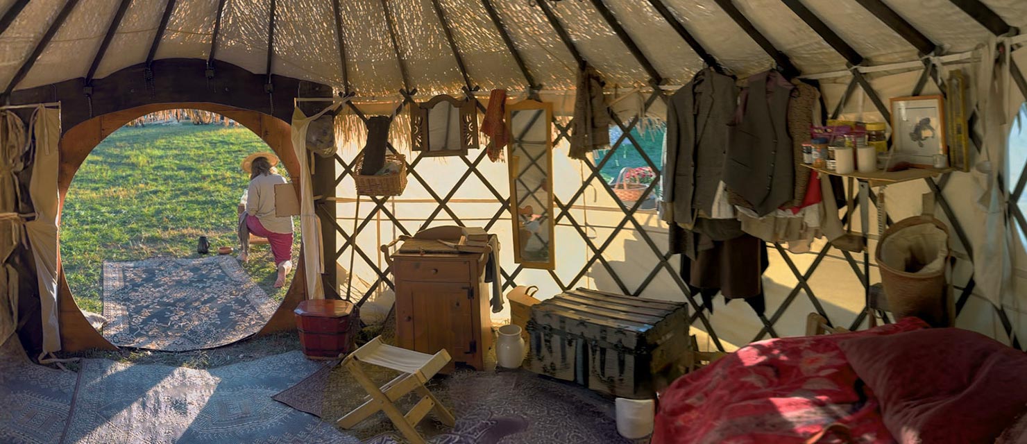 The ThatchTop Burrow — a thatched-roof yurt with a round Hobbit door — at The Brandywine Festival