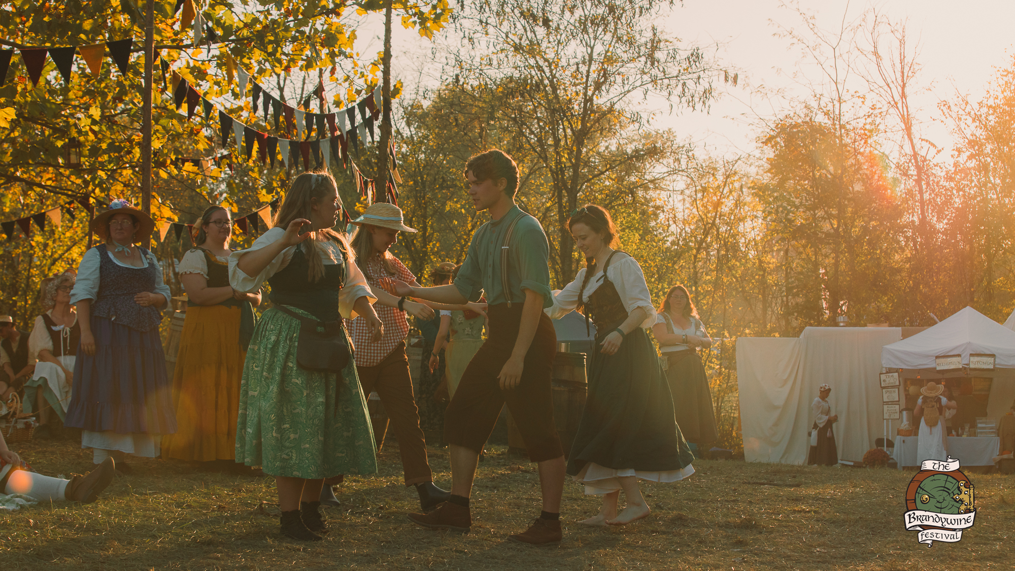 Dancers in the golden light of evening as the bands play